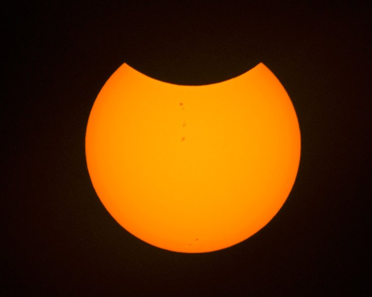 The orange partial eclipse as viewed through TO solar film. Nikon 200-500mm, f/5.6, 1/320, ISO 500.